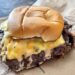 Crispy smash burger stacked high with cheese and onions at Ted’s Burgers in Wynwood, Miami.