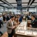 Visitors browsing luxury watch displays at the Miami Jewelry and Watch Show 2027 inside Miami Beach Convention Center